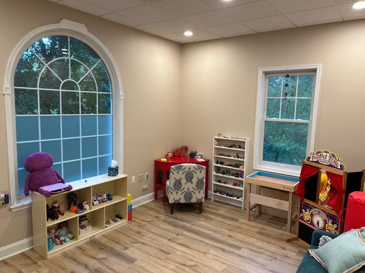 Bright therapy room with arched window at the Schwenksville office.