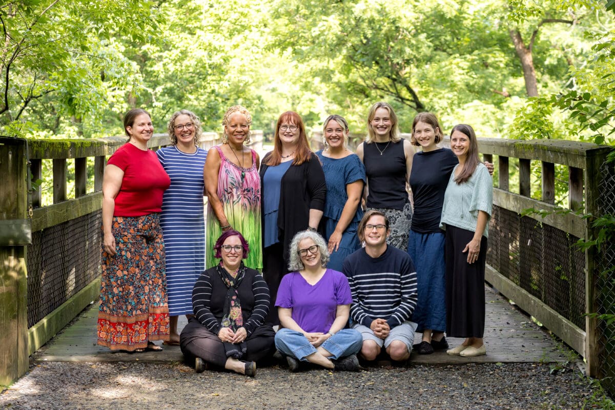 The Flourtown practitioners of The Resiliency Center gathered together on a wooden footbridge